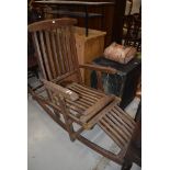 A teak rocking garden recliner chair