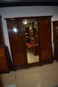 An Edwardian mahogany and inlaid mirror door wardrobe, width approx. 173cm