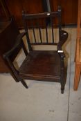 A vintage dark stained carver chair