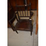 A vintage dark stained carver chair