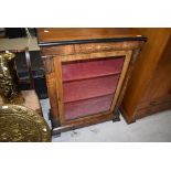 A Victorian empire style display cabinet, having satinwood inlay and brash embelishments, width