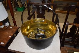 A traditional brass jam pan, two flat irons, horse brasses etc