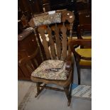 A traditional dark stained beech rocking chair