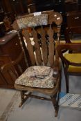 A traditional dark stained beech rocking chair