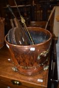 A copper and brass coal bucket, traditional bellows and a selection of fire tools