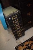 A set of vintage wooden filing or parts drawers having brass label holders