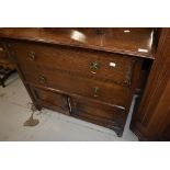 An early 20th Century oak bedroom cabinet having two drawers and double cupboard under