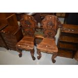 A gorgeous pair of 19th Century mahogany hall chairs having Armorial style rampant lion applique