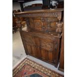 An early 20th Century oak priory style court cupboard