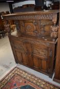 An early 20th Century oak priory style court cupboard