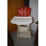 A vintage Childs folding high/low chair , wooden frame and vinyl seat