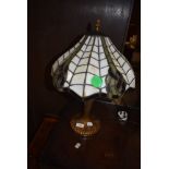 A Tiffany style desk or table lamp having Art Nouveau style base