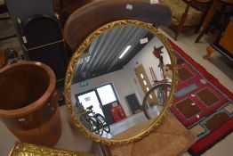 A gilt effect framed mirror