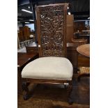 A traditional hardwood nursing chair, possibly Continental having inticrate back, scroll frame and