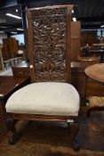 A traditional hardwood nursing chair, possibly Continental having inticrate back, scroll frame and