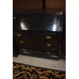 A dark stained bureau in the traditional form with reproduction Georgian style brass handles