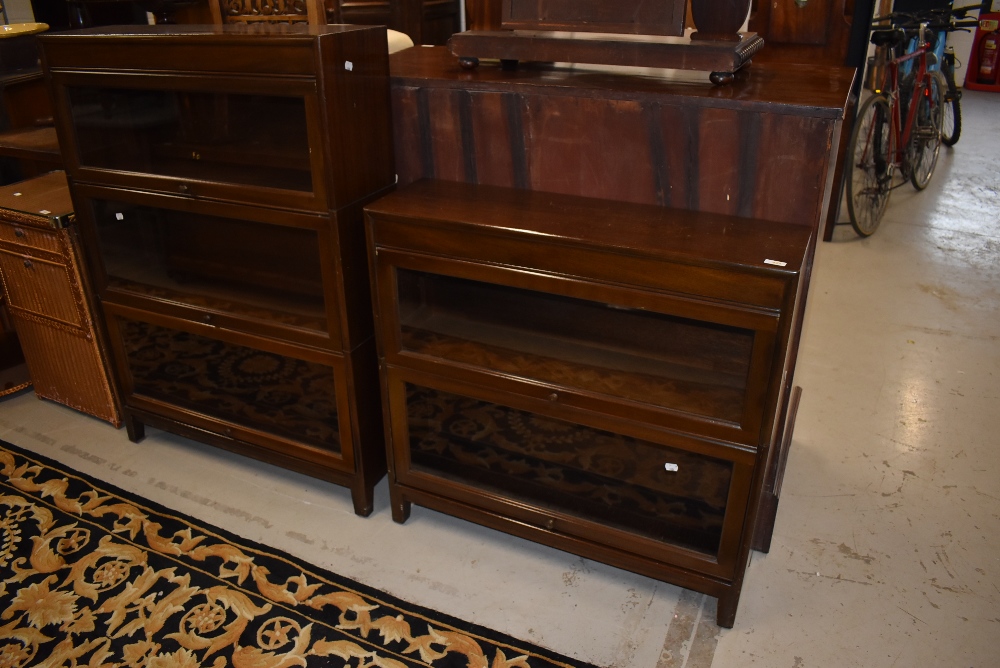 Two early to mid 20th century stacking bookcases, Minty or similar, being two and three tier