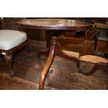 A 19th Century mahogany pedestal table, cut down height, having circular top over turned column