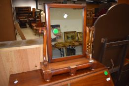 A Victorian mahogany toilet mirror having double concealed drawers to base