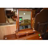 A Victorian mahogany toilet mirror having double concealed drawers to base