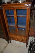 A traditional oak bookcase or display cabinet of slim form, width approx. 62cm