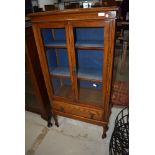 A traditional oak bookcase or display cabinet of slim form, width approx. 62cm