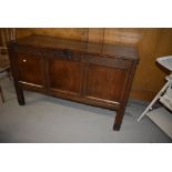 A period oak kist/coffer having typical carved frieze, two plank tip and triple panel front, some