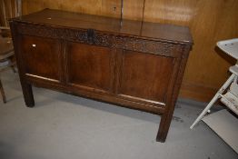 A period oak kist/coffer having typical carved frieze, two plank tip and triple panel front, some