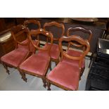 A set of six Victorian mahogany balloon back dining chairs having shaped backs and turned frames