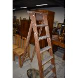 A set of vintage wooden stepladders