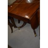 A 19th Century mahogany Pembroke Regency style table on turned splay legs with brass feet and