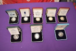 A collection of 8 GB Silver Proof £2 Coins with certificates in cases, 1986 Commonwealth Games