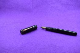A Parker Duofold in black, button fill, with bands missing from cap and slight scratching to barrel