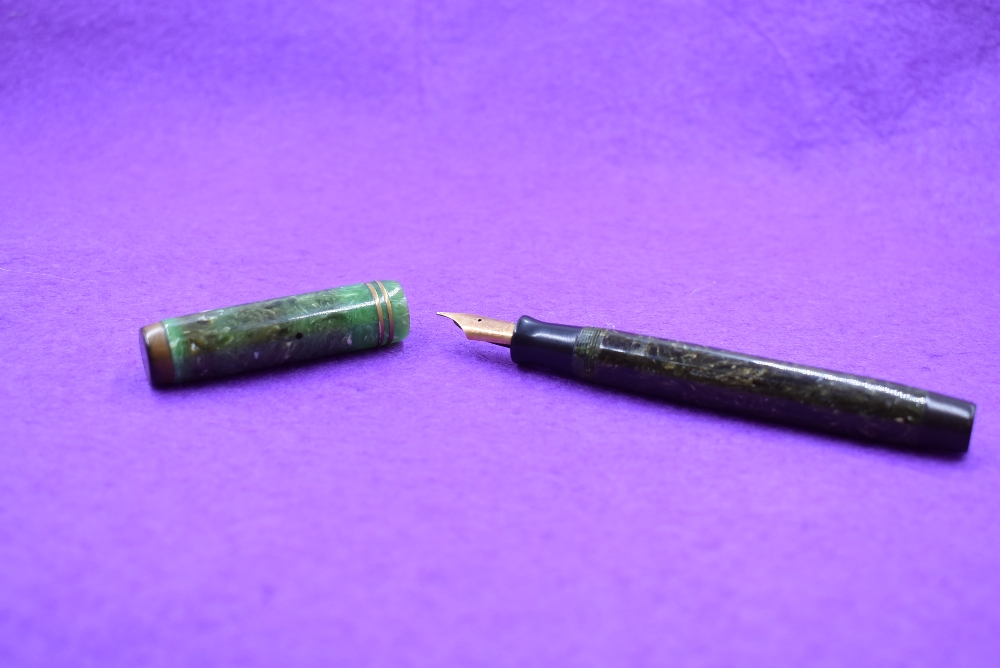 A Parker Duofold button fill fountain pen in green marble, two narrow bands to cap and Parker