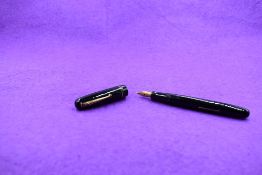 A Mabie Todd & Co Swan 3260 Self Filler Leverfill, in black with two bands to the cap and a Swan No2