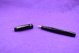 A Unique 'the Unique Pen' leverfill fountain pen in black with a single band to cap. A Unique nib.