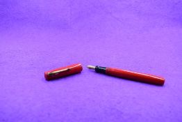 A Mabie Todd & Co Blackbird 5277 Self filler Leverfill fountain pen, in red, a Blackbird nib. Approx