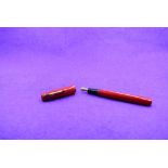 A Mabie Todd & Co Blackbird 5277 Self filler Leverfill fountain pen, in red, a Blackbird nib. Approx