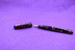 A Croxley 'the Croxley Pen' leverfill fountain pen in red marble with single narrow band to cap, a