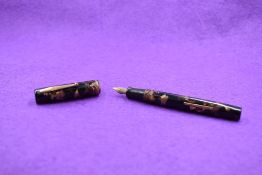 A Watermans Ideal leverfill fountain pen in black and brown marble with a single narrow band to cap,