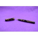 A Watermans Ideal leverfill fountain pen in black and brown marble with a single narrow band to cap,