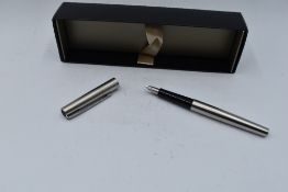 A boxed Parker stainless steel fountain pen