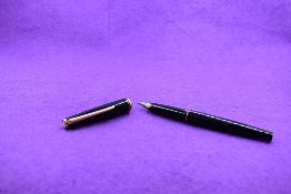 A Montblanc cartridge fountain pen in black with single narrow band to cap and band to rim of cap,