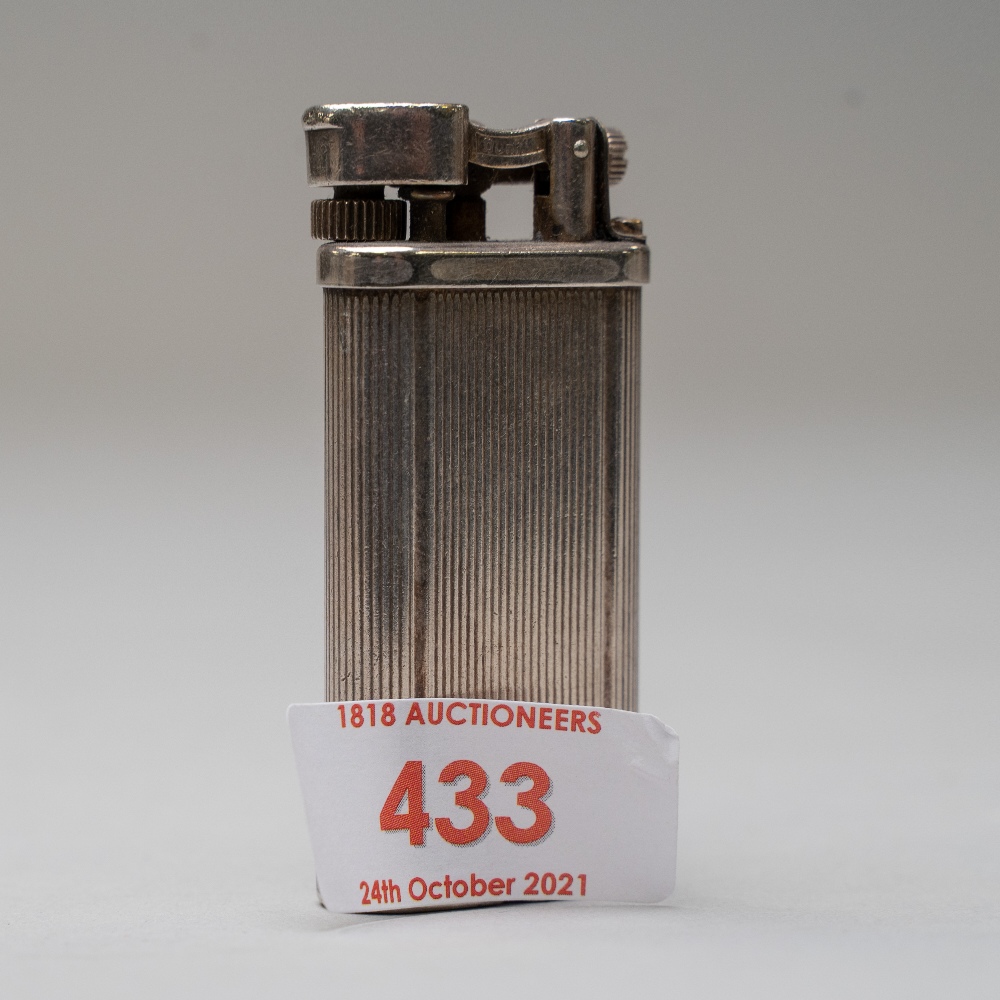 A vintage smokers pocket cigarette lighter by Dunhill from the Unique range marked WF 430299 to base
