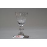 A small wine glass with central knop to stem and decoration to bowl.