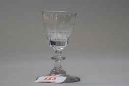 A small wine glass with central knop to stem and decoration to bowl.