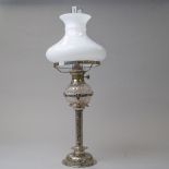 a fine Victorian silver plated oil burning lamp having embossed stem with cut glass well and milk
