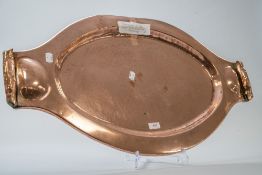 A impressively large oval arts and crafts style tray having hammered base and turn-up handles.