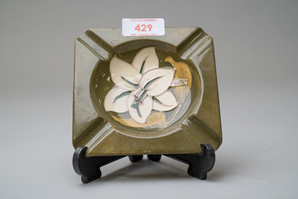 A ceramic ashtray by Moorcroft being stamped to reverse having a green glaze with the Bermuda