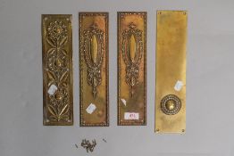 Four early 20th century brass door finger plates, one having floral embossed pattern, two with